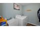 Well-lit laundry room with a utility sink, modern washer and dryer, and stylish decor at 3355 La Vista St, Brooksville, FL 34604