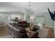 Open-concept living room flowing into the kitchen and dining area with comfortable leather sofas at 3355 La Vista St, Brooksville, FL 34604