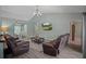 Inviting living room with vaulted ceilings, wood-look tile, and comfortable leather seating at 3355 La Vista St, Brooksville, FL 34604