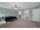 Open and bright main bedroom with carpet, ceiling fan and easy access to en-suite bathroom and closet at 3355 La Vista St, Brooksville, FL 34604