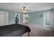 Spacious main bedroom with plush carpet, a ceiling fan, and views of the home's walk-in closet at 3355 La Vista St, Brooksville, FL 34604
