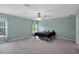 Bright main bedroom featuring carpet and ceiling fan in a new listing for sale at 3355 La Vista St, Brooksville, FL 34604