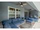 Relaxing covered patio with outdoor seating, ceiling fans, and a view of the screened pool area at 3355 La Vista St, Brooksville, FL 34604