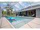 Enjoy this refreshing screened-in pool with room for relaxation, water features, and backyard views at 3355 La Vista St, Brooksville, FL 34604