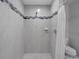 Tiled walk-in shower featuring sleek fixtures, accent tiling, and a convenient hand shower at 3355 La Vista St, Brooksville, FL 34604