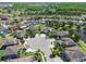 Expansive aerial view of a vibrant community boasting lush greenery, tranquil ponds, and well-maintained homes at 3555 Bracknell Ct, Land O Lakes, FL 34638