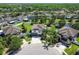 Aerial community view featuring a neighborhood with landscaped yards, serene pond, and community amenities at 3555 Bracknell Ct, Land O Lakes, FL 34638