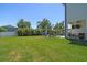 Expansive backyard with a manicured lawn and comfortable seating area, creating an inviting outdoor space for leisure at 3555 Bracknell Ct, Land O Lakes, FL 34638