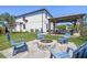 Spacious backyard featuring a fire pit, gazebo, and ample seating for outdoor entertainment at 3555 Bracknell Ct, Land O Lakes, FL 34638