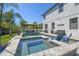 Gorgeous backyard with a pool, spa, and gazebo, complete with ample seating and lush landscaping for outdoor enjoyment at 3555 Bracknell Ct, Land O Lakes, FL 34638