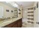 Bright bathroom featuring granite countertops, double sinks, and a shower-tub combo at 3555 Bracknell Ct, Land O Lakes, FL 34638