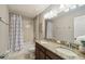 Bright bathroom features a double sink vanity with granite countertops and a tub with shower at 3555 Bracknell Ct, Land O Lakes, FL 34638