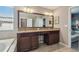 Bathroom featuring a double vanity with dark wood cabinets and granite countertops at 3555 Bracknell Ct, Land O Lakes, FL 34638