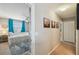 Bright bedroom with window and decorated rug as seen from the hallway at 3555 Bracknell Ct, Land O Lakes, FL 34638
