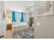 Light bedroom with blue curtains and a ceiling fan, decorated with art at 3555 Bracknell Ct, Land O Lakes, FL 34638