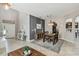 Bright dining room with modern lighting adjacent to the kitchen and an arched entryway at 3555 Bracknell Ct, Land O Lakes, FL 34638