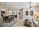 Open-concept dining area featuring decorative lighting, open archways, and tile flooring at 3555 Bracknell Ct, Land O Lakes, FL 34638
