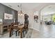Bright dining area with modern lighting, open to the kitchen and other living spaces at 3555 Bracknell Ct, Land O Lakes, FL 34638