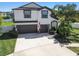 Charming two-story home featuring a well-maintained lawn, mature landscaping, and a spacious two-car garage at 3555 Bracknell Ct, Land O Lakes, FL 34638