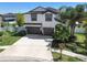 Two-story home with three-car garage, well-manicured lawn, and an American flag at 3555 Bracknell Ct, Land O Lakes, FL 34638