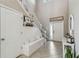 Bright foyer with staircase and bench seating, featuring neutral colors, modern light fixtures, and decor at 3555 Bracknell Ct, Land O Lakes, FL 34638