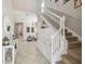 Bright foyer with staircase, bench seating, modern light fixtures, and neutral decor at 3555 Bracknell Ct, Land O Lakes, FL 34638