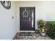 Charming front door adorned with a wreath, welcoming guests with a cozy and inviting feel at 3555 Bracknell Ct, Land O Lakes, FL 34638