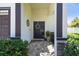 Charming front entrance with a decorative wreath, stone accents, and a neatly landscaped garden at 3555 Bracknell Ct, Land O Lakes, FL 34638