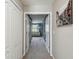Open hallway with neutral tones and views into the living room, showcasing the home's layout at 3555 Bracknell Ct, Land O Lakes, FL 34638
