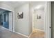 Neutral hallway showcasing artwork, leading to various rooms of the home at 3555 Bracknell Ct, Land O Lakes, FL 34638