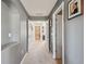 Well-lit hallway with neutral paint that connects various rooms within the home at 3555 Bracknell Ct, Land O Lakes, FL 34638