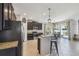 Open-concept kitchen featuring granite countertops, an island with seating, and dark cabinets at 3555 Bracknell Ct, Land O Lakes, FL 34638