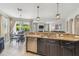 Granite countertop and stainless appliances in open kitchen with view to dining and living area at 3555 Bracknell Ct, Land O Lakes, FL 34638