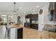 Open kitchen with granite countertops, stainless appliances, a bar, and tiled floors at 3555 Bracknell Ct, Land O Lakes, FL 34638