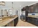 A kitchen features granite countertops, stainless steel appliances, and dark wood cabinets at 3555 Bracknell Ct, Land O Lakes, FL 34638