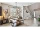 Cozy living room with a neutral color palette, modern lighting, and stairs at 3555 Bracknell Ct, Land O Lakes, FL 34638