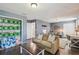 Open-concept living room featuring hardwood floors and access to a bright home office space at 3555 Bracknell Ct, Land O Lakes, FL 34638