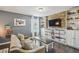Comfortable living room features built-in shelving, hardwood floors, and natural light at 3555 Bracknell Ct, Land O Lakes, FL 34638