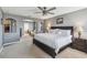 Spacious main bedroom features a ceiling fan, neutral paint and carpet, and an open layout at 3555 Bracknell Ct, Land O Lakes, FL 34638