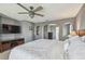 Spacious main bedroom boasts a ceiling fan, a TV, and arched entryways at 3555 Bracknell Ct, Land O Lakes, FL 34638