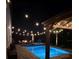 Relaxing poolside view with stylish lounge furniture and ambient string lights, ideal for evening gatherings and leisure at 3555 Bracknell Ct, Land O Lakes, FL 34638