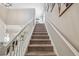 Carpeted staircase with white railings, leading to a brightly lit upper level at 3555 Bracknell Ct, Land O Lakes, FL 34638