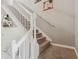 Staircase with white railings and carpeted steps leading to the upper level at 3555 Bracknell Ct, Land O Lakes, FL 34638