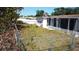 Fenced backyard with a screen-enclosed porch offers an outdoor living space at 3752 Fox Dale Ln, Holiday, FL 34691