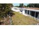 This home has a spacious backyard with white fencing and mature trees at 3752 Fox Dale Ln, Holiday, FL 34691