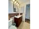 Cozy bathroom featuring dark wood vanity and decorative tile backsplash at 3752 Fox Dale Ln, Holiday, FL 34691