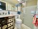 Bathroom with updated vanity, toilet and glass enclosed shower at 3752 Fox Dale Ln, Holiday, FL 34691