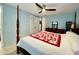 Bedroom with four poster bed, ceiling fan, and blue walls at 3752 Fox Dale Ln, Holiday, FL 34691