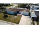 Aerial view of charming one-story home with a driveway and well-kept lawn and landscaping at 3752 Fox Dale Ln, Holiday, FL 34691