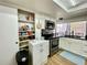 This kitchen features stainless steel appliances, white cabinets, granite counter tops, and a pantry at 3752 Fox Dale Ln, Holiday, FL 34691